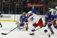 Columbus Blue Jackets right wing Oliver Bjorkstrand (28) tries to shoot against New York Rangers goaltender Igor Shesterkin (31) with Rangers center Mika Zibanejad (93) defending during the first period of an NHL hockey game, Sunday, Jan. 19, 2020, in New York. (AP Photo/Kathy Willens)