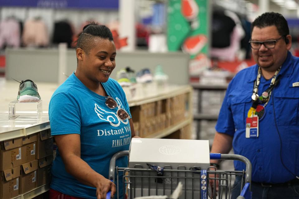 Jae Lee, left, shops at Academy Sports + Outdoor after five Season for Caring families received a $1,000 gift cards. It had been years since he had been able to buy clothes for himself.