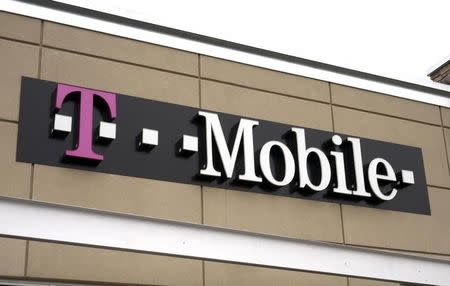 A T-Mobile store sign is seen in Broomfield, Colorado February 25, 2014. REUTERS/Rick Wilking