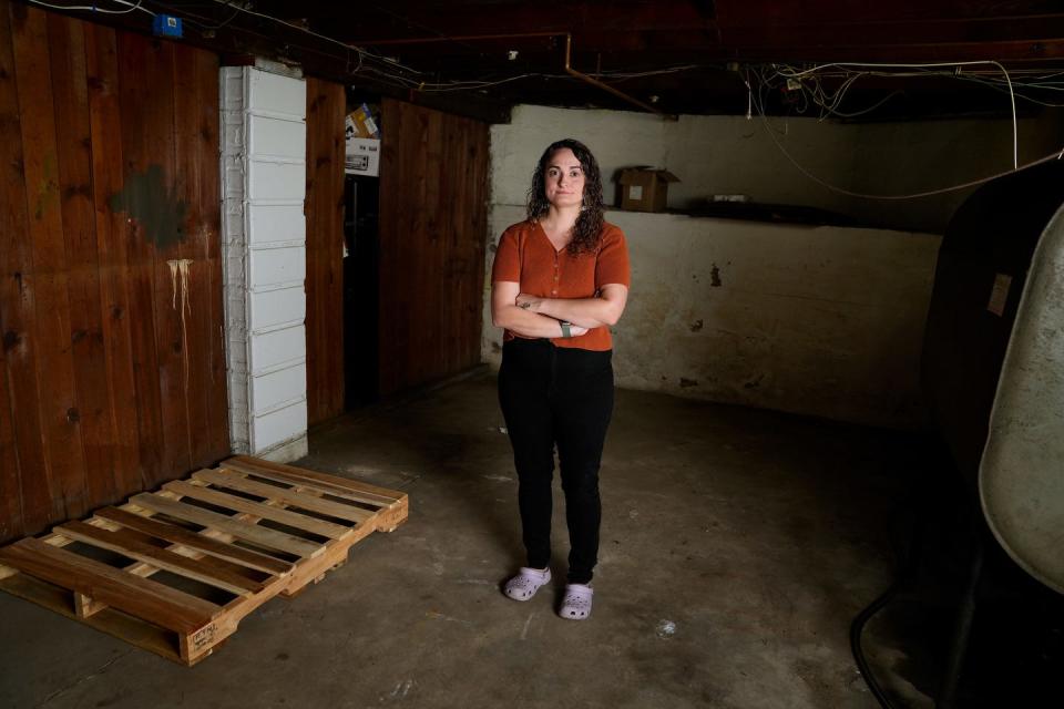 Sydney Hunt, in the empty basement of her apartment, cleared her belongings from it when a July 4 storm flooded the yard and basement.