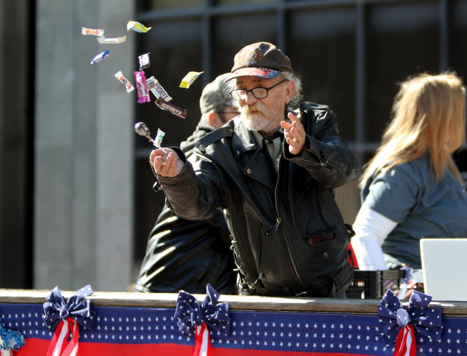 A man with the American Legion throws out candy Saturday, Nov. 2, 2019, at the Veterans Day Parade in downtown Wichita Falls.