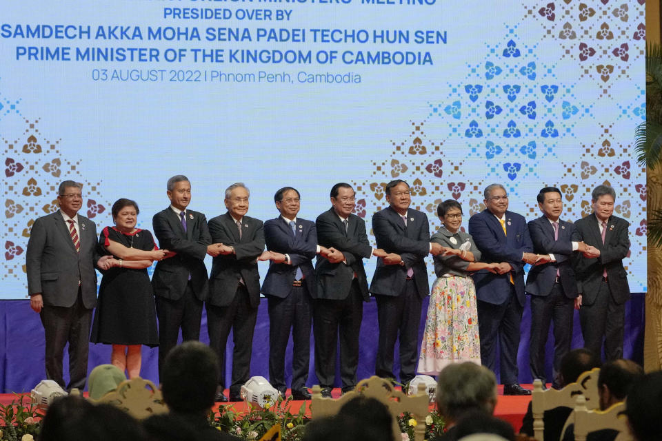 From left to right; Malaysian Foreign Minister Saifuddin Abdullah, Philippines Foreign Affairs acting Undersecretary Theresa Lazaro, Singapore Foreign Minister Vivian Balakrishnan, Thailand's Foreign Minister Don Pramudwinai, Vietnam Foreign Minister But Thanh Son, Cambodia's Prime Minister Hun Sen, Cambodia's Foreign Minister Peak Sokhonn, Indonesia's Foreign Minister Retno Marsudi, Brunei Second Minister of Foreign Affairs Erywan Yusof, Laos Foreign Minister Saleumxay Kommasith, and Secretary-General of ASEAN Lim Jock Hoi poses for a group photograph during the opening for the 55th ASEAN Foreign Ministers' Meeting (55th AMM) in Phnom Penh, Cambodia, Wednesday, Aug. 3, 2022. Southeast Asian foreign ministers are gathering in the Cambodian capital for meetings addressing persisting violence in Myanmar and other issues, joined by top diplomats from the United States, China, Russia and other world powers amid tensions over the invasion of Ukraine and concerns over Beijing's growing ambitions in the region. (AP Photo/Vincent Thian)