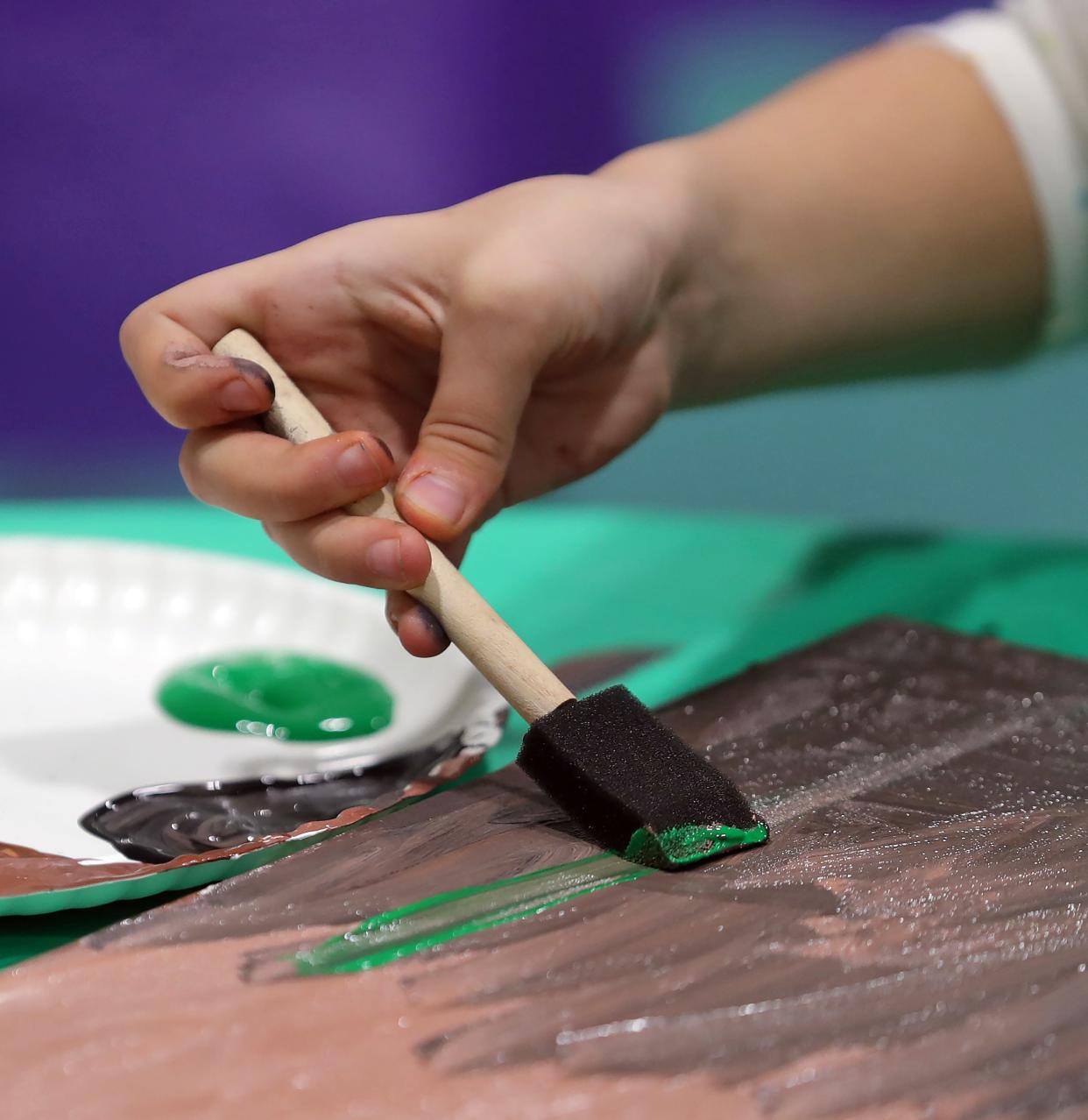 A child paints during an Integrated Community Solutions art class.