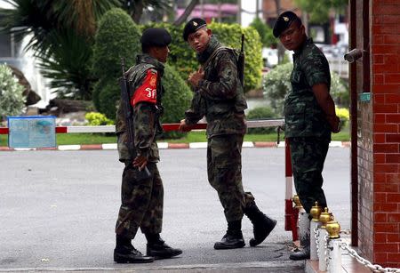 Thai Army officers stand guard at a gate of the military barracks believed to be holding two arrested bomb suspects involved in the recent Bangkok blast in Bangkok, Thailand, September 2, 2015. REUTERS/Chaiwat Subprasom