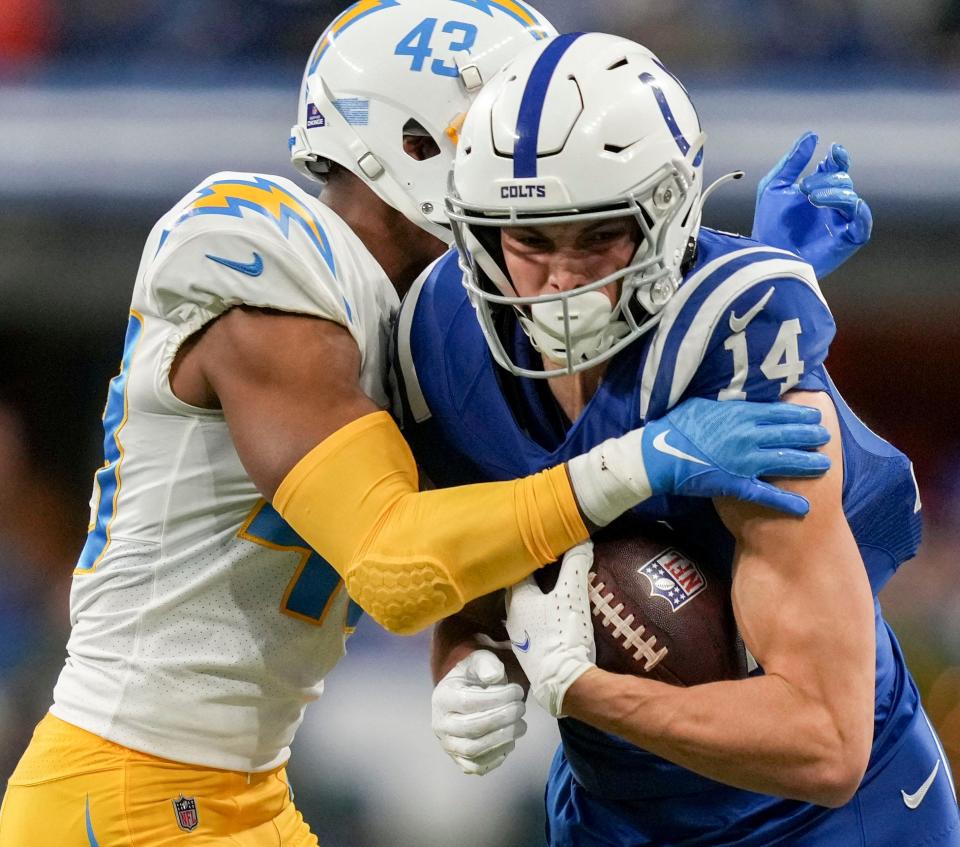 Los Angeles Chargers cornerback Michael Davis (43) works to bring down Indianapolis Colts wide receiver Alec Pierce (14) on Monday, Dec. 26, 2022, during a game against the Los Angeles Chargers at Lucas Oil Stadium in Indianapolis.
