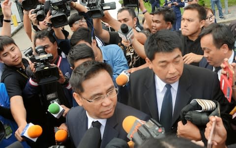 Lawyers of former Yingluck Shinawatra are surrounded by media reporters after she failed to appear the Supreme Court on Friday - Credit: The Asahi Shimbun via Getty Images