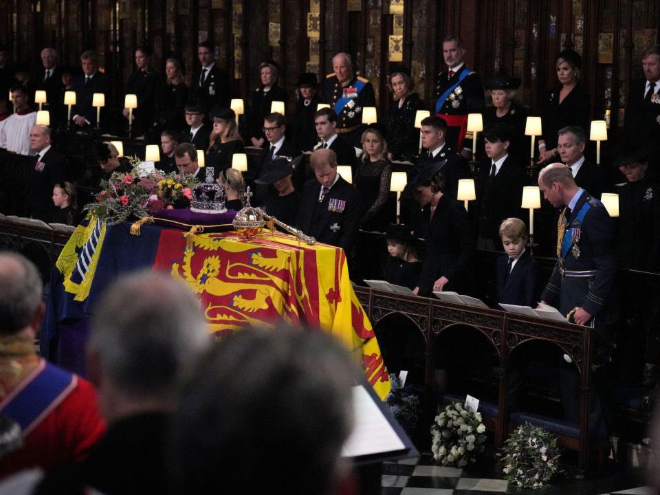The royal family stands near the Queen's coffin during her Committal Service at St. George's Chapel.