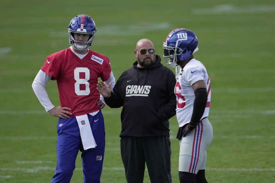 From left, New York Giants quarterback Daniel Jones, number 8, head coach Brian Daboll and running back Saquon Barkley, number 26, attend a practice session at Hanbury Manor in Ware, England, Friday, Oct. 7, 2022 ahead the NFL game against Green Bay Packers at the Tottenham Hotspur stadium on Sunday. (AP Photo/Kin Cheung)