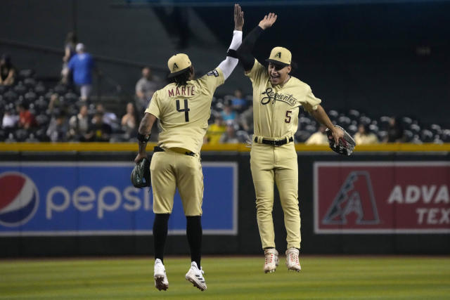 Nick Ahmed of the Arizona Diamondbacks celebrates in the dugout