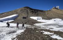 Hikers walk past the newly uncovered Zanfeluron path at Glacier 3000 in Les Diablerets