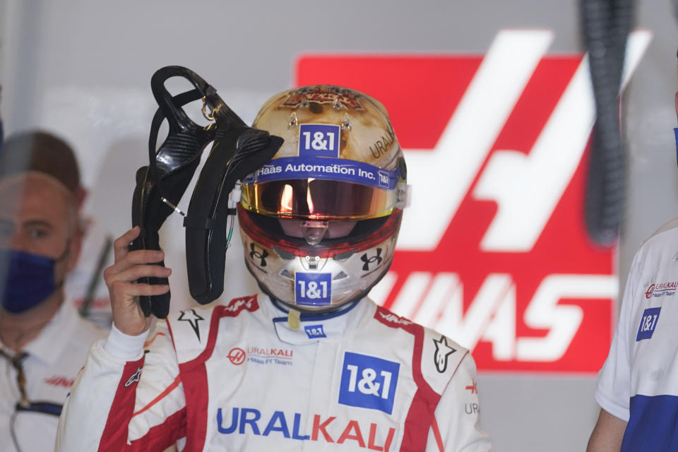 Haas driver Mick Schumacher, of Germany, walks to his car before a practice session for the F1 US Grand Prix auto race at Circuit of the Americas, Friday, Oct. 22, 2021, in Austin, Texas. (AP Photo/Darron Cummings)