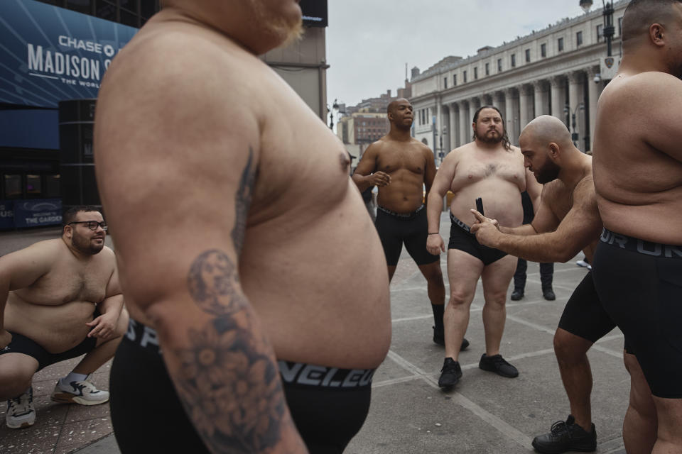 Sumo wrestlers stand outside Madison Square Garden during the presentation of the Sumo World Championship, Friday, April 12, 2024, in New York. (AP Photo/Andres Kudacki)