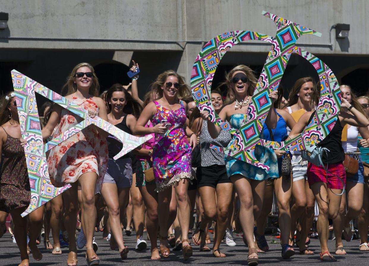 <span class="caption">The University of Alabama's Alpha Phi sorority runs out of Bryant-Denny Stadium during bid day in 2014.</span> <span class="attribution"><a class="link " href="https://newsroom.ap.org/detail/AlabamaSororities/2f63d36f739d40aea211a77cb69ac367/photo?Query=alabama%20AND%20sorority&mediaType=photo&sortBy=&dateRange=Anytime&totalCount=50&currentItemNo=26" rel="nofollow noopener" target="_blank" data-ylk="slk:AP Photo/Brynn Anderson;elm:context_link;itc:0;sec:content-canvas">AP Photo/Brynn Anderson</a></span>