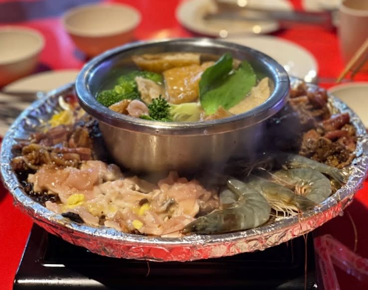 Queen City Steamboat and Grill - Meat on a grill and a hot pot