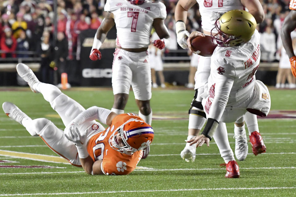 Boston College quarterback Phil Jurkovec, right, falls to the turf, next to Clemson's Keith Maguire during the first half of an NCAA college football game Saturday Oct. 8, 2022, in Boston. (AP Photo/Mark Stockwell)