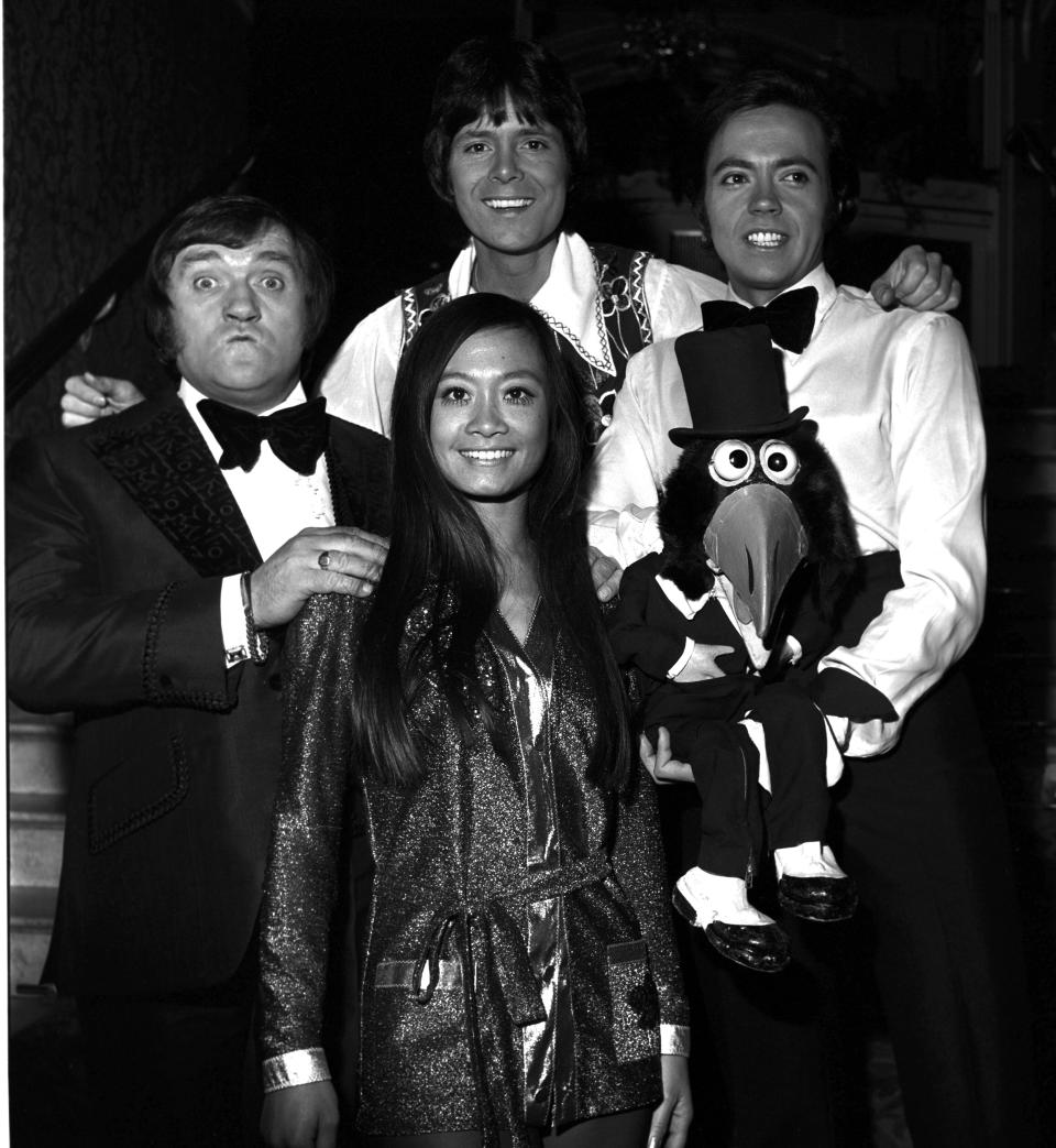 Les Dawson (left) Cliff Richard (Centre back) Wei Wei Wong (centre front) Jose Luis Moreno (right) in November 1973.;  (Photo by Monitor Picture Library/Photoshot/Getty Images)