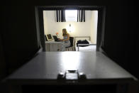 A model poses in a room of the Alcatraz hotel in the southwestern German city of Kaiserslautern September 19, 2008. The hotel, built in a former prison from 1867 today offers a total of 57 rooms, with original carceral beds, lattice bars and pass-throughs in the heavy steel doors. REUTERS/Alex Grimm