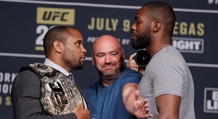 Dana White, center, stands between Daniel Cormier, left, and Jon Jones. (John Locher/AP)