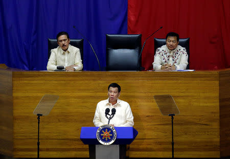 Philippine President Rodrigo Duterte delivers his State of the Nation address at the House of Representatives in Quezon city, Metro Manila, in Philippines July 23, 2018. At the upper podium (L-R) Senate President Vicente Sotto and Speaker of the House Pantaleon Alvarez. REUTERS/Czar Dancel