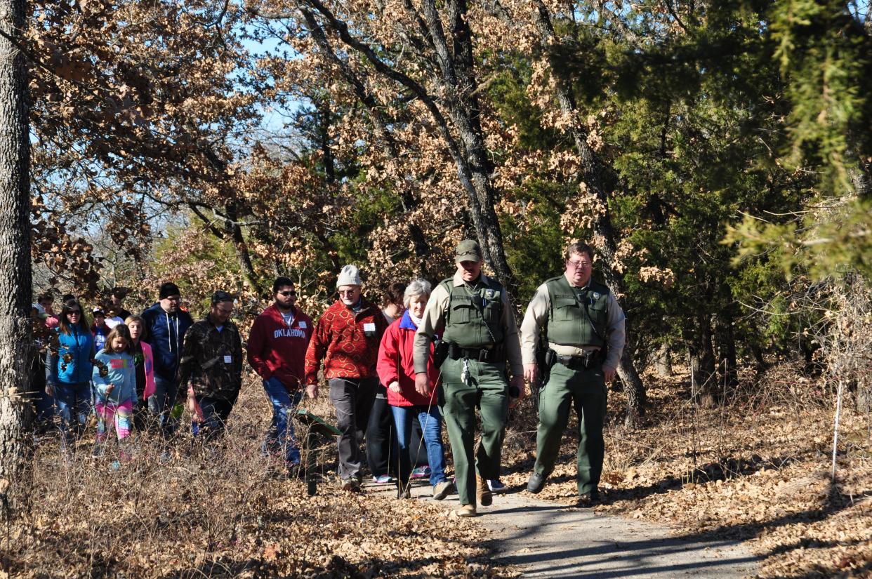 Rangers lead people on a First Day Hike at Lake Thunderbird State Park.