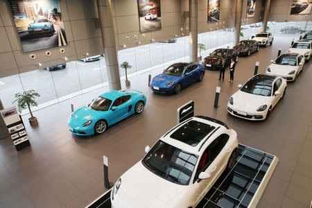 Imported Porsche cars are seen inside a showroom in Nantong, Jiangsu province, China May 22, 2018. Picture taken May 22, 2018. REUTERS/Stringer