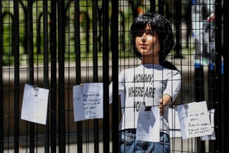 A sculpture by artist Marilyn Miller depicts a life-size immigrant child separated by cages from the mother in New York City, U.S., July 19, 2018. REUTERS/Brendan McDermid