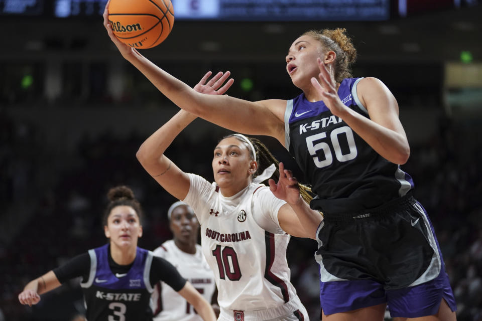 Kansas State center Ayoka Lee (50) grabs a rebound against South Carolina center Kamilla Cardoso (10) during the first half of an NCAA college basketball game Friday, Dec. 3, 2021, in Columbia, S.C. (AP Photo/Sean Rayford)