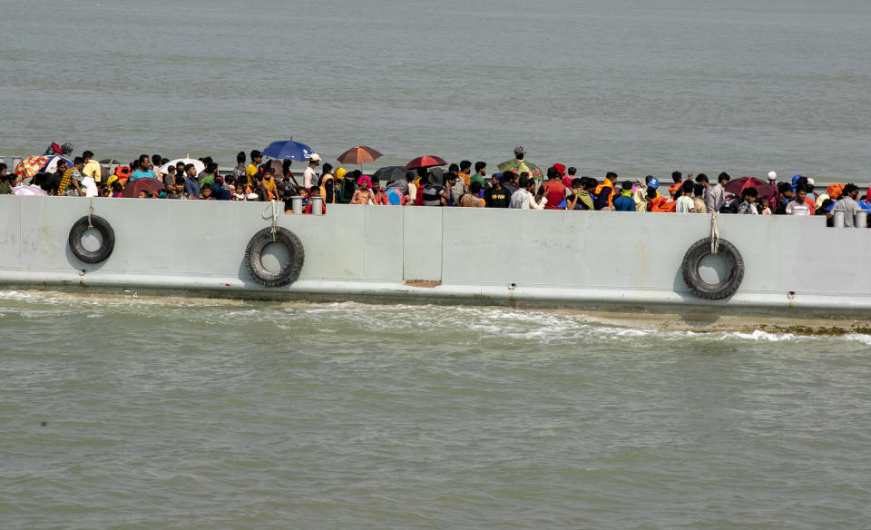 Rohingya refugees travel on a naval vessel that will take them to Bhasan Char island, in Chittagong, Bangladesh, Thursday, Nov. 25, 2012. Thousands have been relocated on the island in the Bay of Bengal from crammed camps near the Myanmar border. (AP Photo)