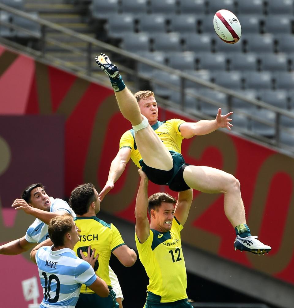 Australia's Henry Hutchinson gets a little help from teammate Lachlan Anderson