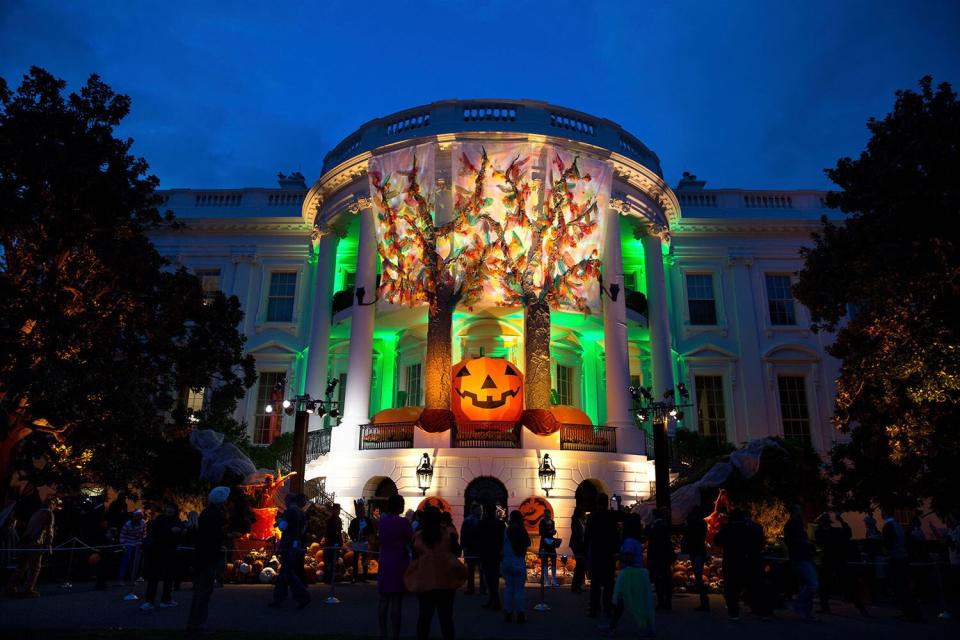 This photograph, taken by Pete Souza on October 31, 2014, shows the South Portico of the White House festively decorated for a Halloween celebration hosted by President Barack Obama and First Lady Michelle Obama for local children and military families. The decorations included large inflatable pumpkins and facades of trees with autumnal leaves.