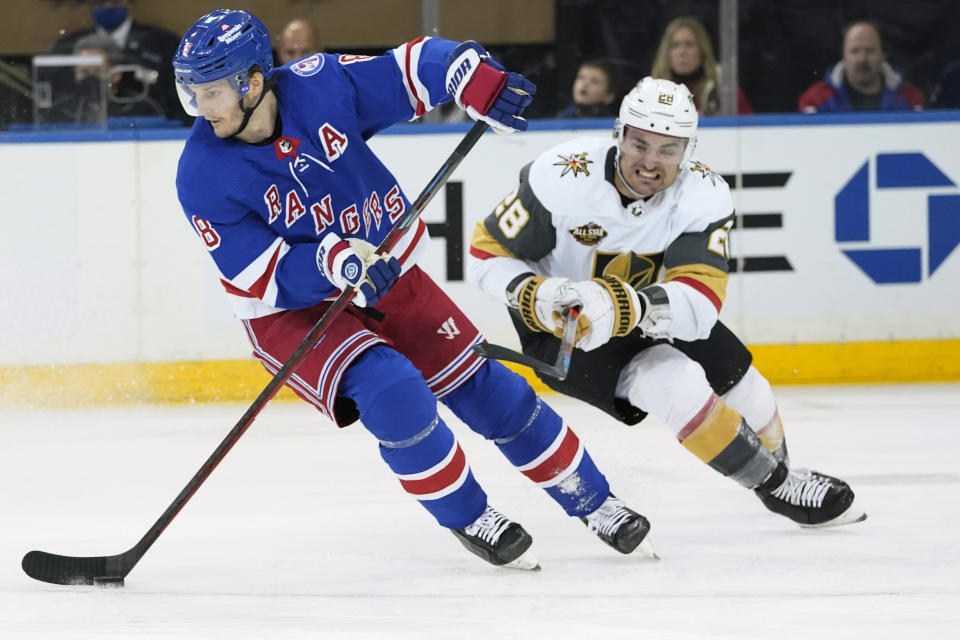 New York Rangers defenseman Jacob Trouba (8) skates against Vegas Golden Knights left wing William Carrier (28) during the second period of an NHL hockey game, Friday, Dec. 17, 2021, at Madison Square Garden in New York. (AP Photo/Mary Altaffer)