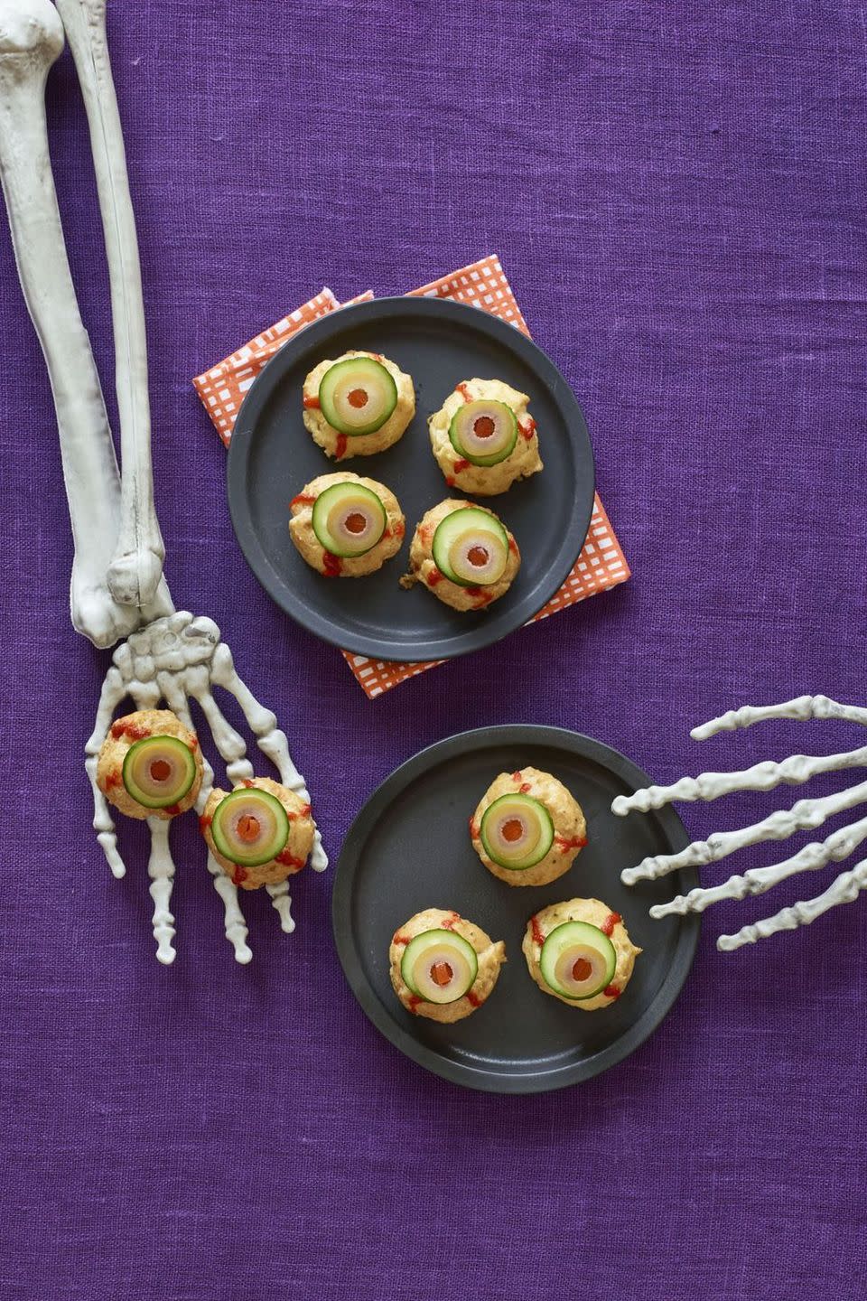 <p>Hey, we'd take these cheese puff eyeballs over peeled grapes as eyeballs any day — especially since they have a squirt of Sriracha. </p><p>Get the <a href="https://www.womansday.com/food-recipes/recipes/a60165/bitesize-eyeballs-recipe/" rel="nofollow noopener" target="_blank" data-ylk="slk:Bite-Size Eyeballs recipe;elm:context_link;itc:0;sec:content-canvas" class="link "><strong>Bite-Size Eyeballs recipe</strong></a> from Woman's Day. </p>