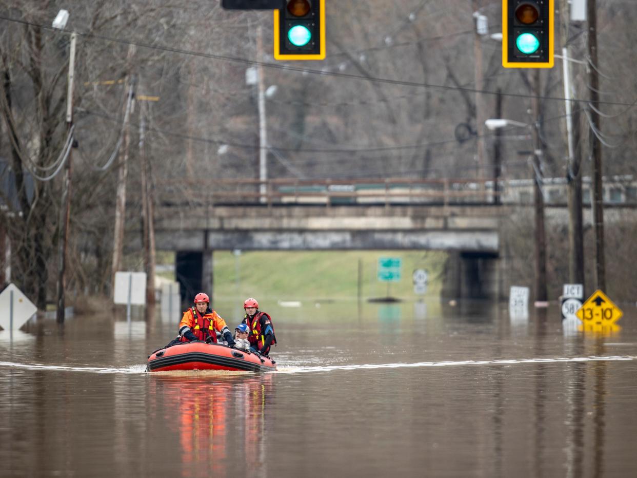 <p>Michael Oiler, left, of the Thelma Fire Department, and Ricky Keeton, of the Oil Springs Fire Department, conduct a water rescue in Paintsville, Ky., following heavy rain on Monday 1 March 2021</p> ((Associated Press))