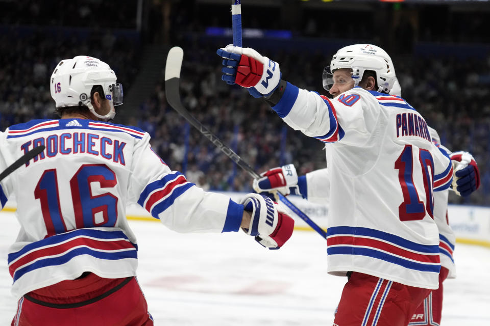 New York Rangers left wing Artemi Panarin (10) celebrates his goal against the Tampa Bay Lightning with center Vincent Trocheck (16) during the first period of an NHL hockey game Saturday, Dec. 30, 2023, in Tampa, Fla. (AP Photo/Chris O'Meara)