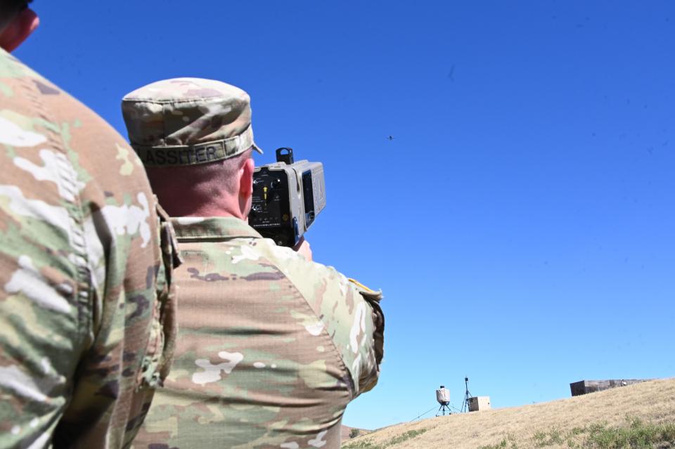 A US service member points a handheld device at a drone at the JCU in October, 2023.