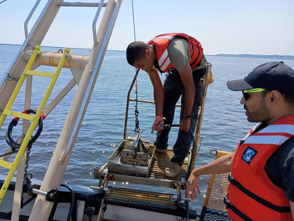 A high school student hoses sand off a sample from the bottom of Lake Michigan to see what's left behind. The research was part of a UW-Milwaukee program for Milwaukee high school students.