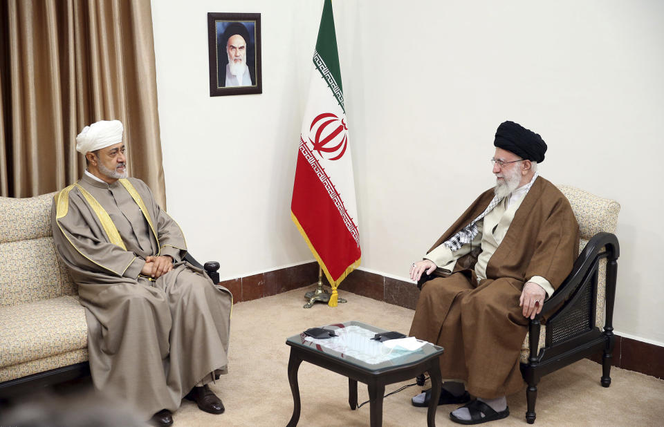 In this picture released by the office of the Iranian supreme leader, Supreme Leader Ayatollah Ali Khamenei, right, meets with Oman's Sultan Haitham bin Tariq Al Said, in Tehran, Iran, Monday, May 29, 2023. A portrait of the late Iranian revolutionary founder Ayatollah Khomeini hangs on the wall. (Office of the Iranian Supreme Leader via AP)