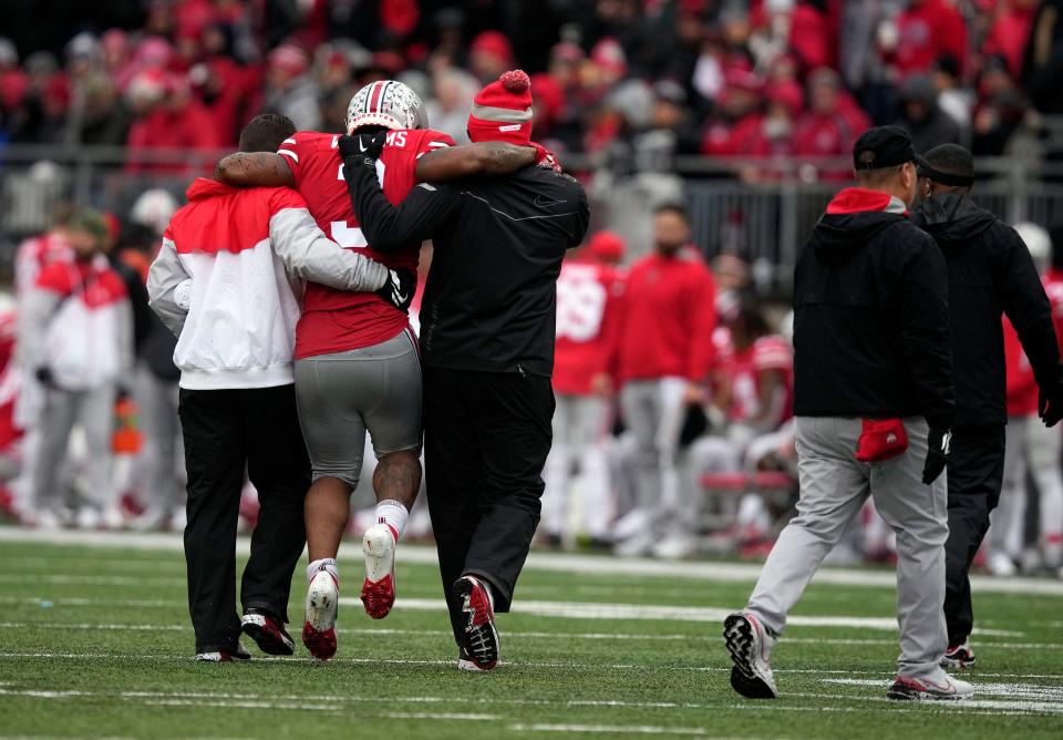 Ohio State running back Miyan Williams is helped off the field in the second quarter Saturday.