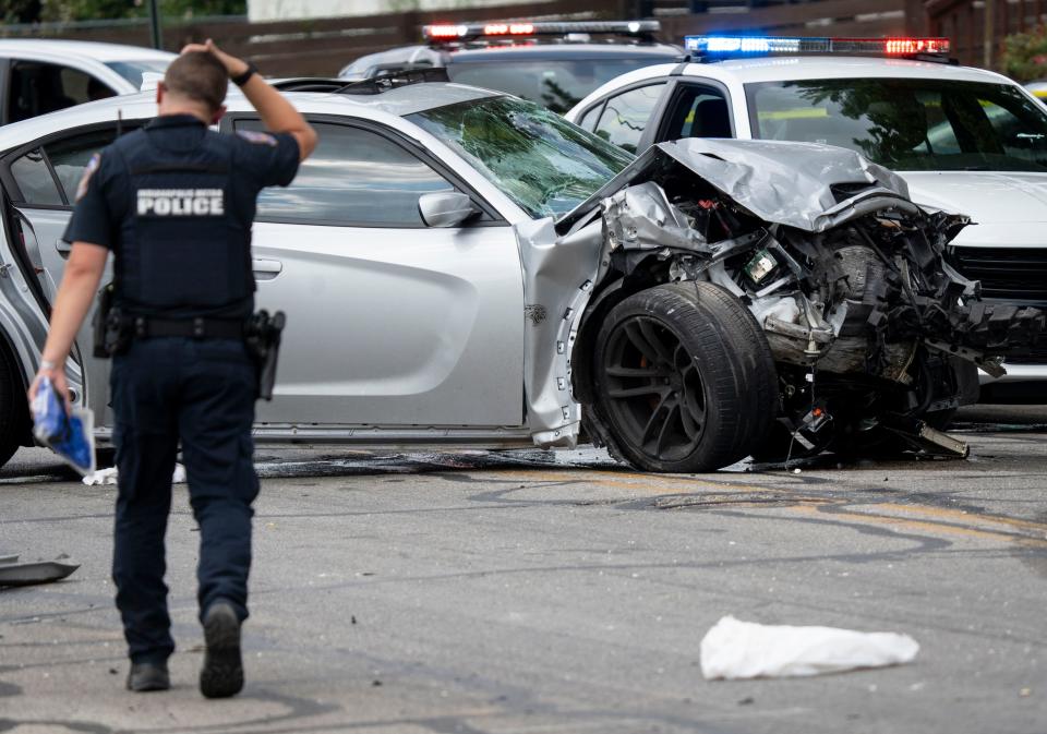 Law enforcement officials work the scene of an accident that officials say left left six kids and two adults injured on Tuesday, July 23, 2024, near the intersection of North State Avenue and East New York Street in Indianapolis.