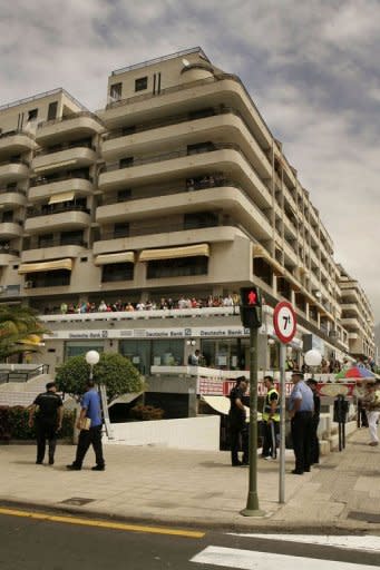 Policemen secure the area around a supermarket where a man decapitated a British woman in Los Cristianos, on the Spanish resort island of Tenerife