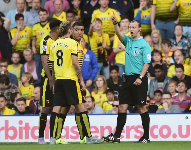 Madley, right, in action in the Premier League