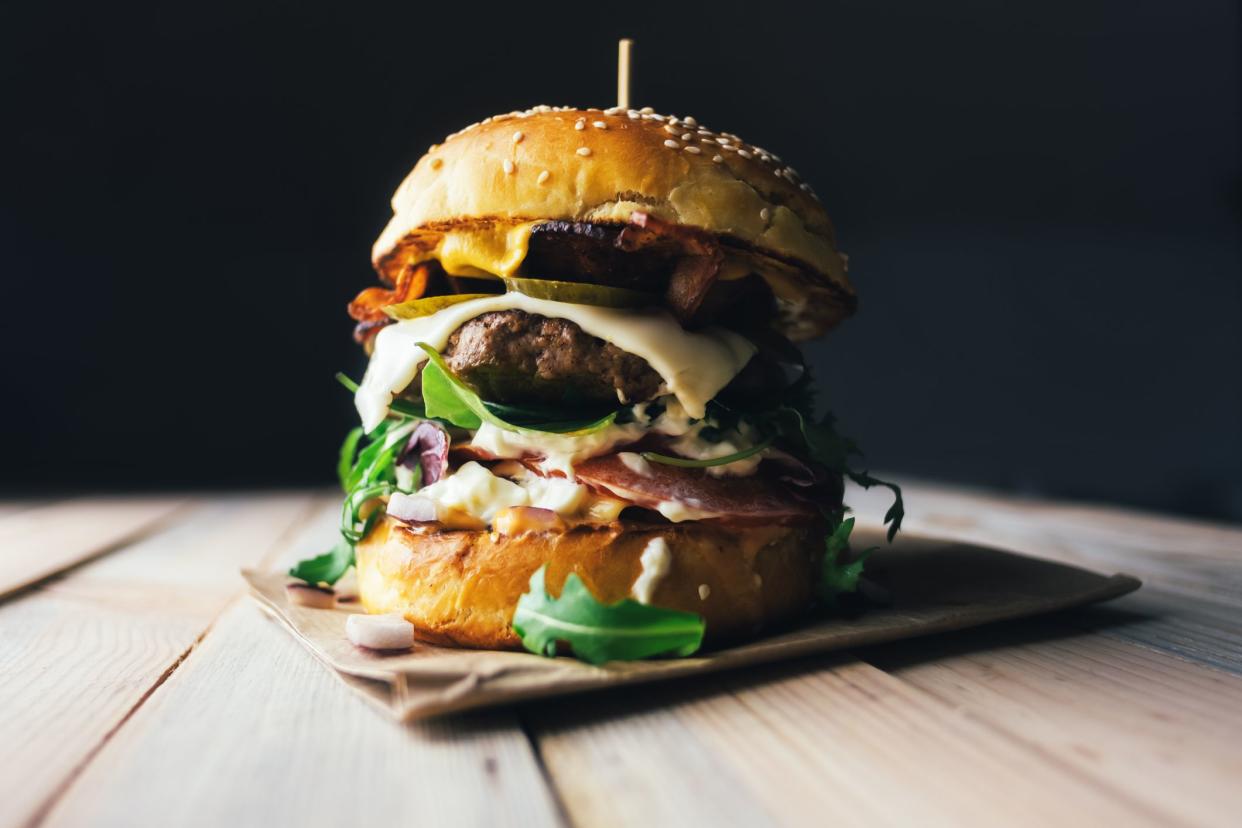 Appetizing cheeseburger on wooden table. Flat lay. Food photography