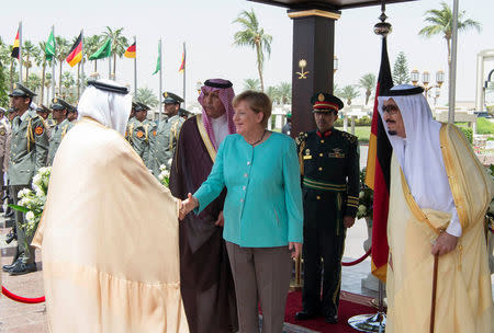 Saudi Arabia's King Salman bin Abdulaziz Al Saud stands next to German Chancellor Angela Merkel during a reception ceremony in Jeddah, Saudi Arabia April 30, 2017. Bandar Algaloud/Courtesy of Saudi Royal Court/Handout via REUTERS