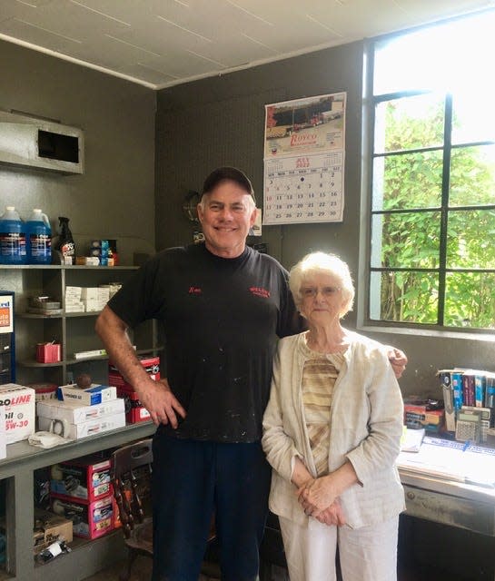 Ronnie Miller, owner of Miller's Garage, poses with customer Blanche Kinner on his last day on the job before retirement.