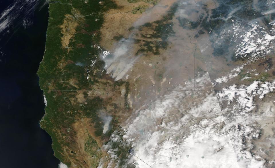 This satellite image provided by Satellite image ©2021 Maxar Technologies shows overview of wildfires from Oregon, Idaho, and Northern California on Sunday, July 18, 2021. Extremely dry conditions and heat waves tied to climate change have made wildfires harder to fight. Climate change has made the West much warmer and drier in the past 30 years and will continue to make weather more extreme and wildfires more frequent and destructive. (Satellite image ©2021 Maxar Technologies via AP)