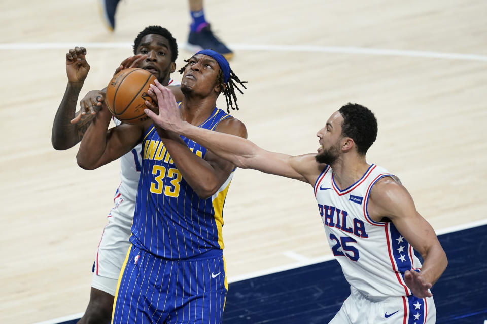 Indiana Pacers' Myles Turner (33) puts up a shot against Philadelphia 76ers' Ben Simmons (25) during the first half of an NBA basketball game, Sunday, Jan. 31, 2021, in Indianapolis. (AP Photo/Darron Cummings)