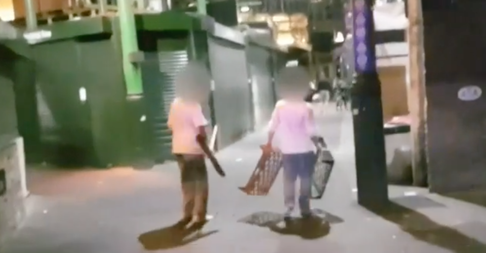 Two bakers rush from their premises to help out, carrying a broom and bread crates. Source: BBC