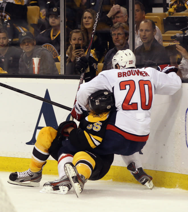 BOSTON, MA - APRIL 21: Johnny Boychuk #55 of the Boston Bruins and Troy Brouwer #20 of the Washington Capitals mix it up in the second period in Game Five of the Eastern Conference Quarterfinals during the 2012 NHL Stanley Cup Playoffs at TD Garden on April 21, 2012 in Boston, Massachusetts. The Capitals defeated the Bruins 4-3. (Photo by Bruce Bennett/Getty Images)