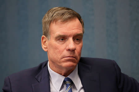 FILE PHOTO - Sen. Mark Warner (D-VA) listens to military families discuss their hazardous living conditions during a meeting at the Peninsula Workforce Development Office in Newport News, Virginia, U.S. March 11, 2019. REUTERS/Ryan M. Kelly