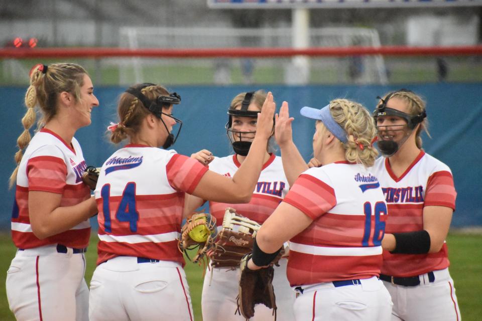 Martinsville is all smiles as they high five before the start of an inning during the Artesians' game with Plainfield on April 20, 2022.